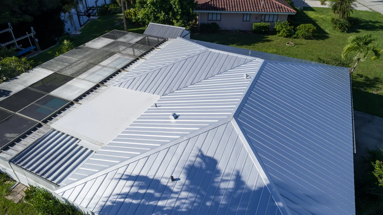 Metal panels across intersecting hip roof sections, Bokeelia