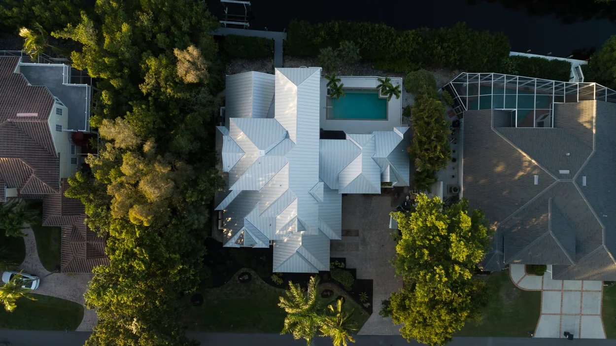 Overhead view of metal roofing and adjoining roof sections