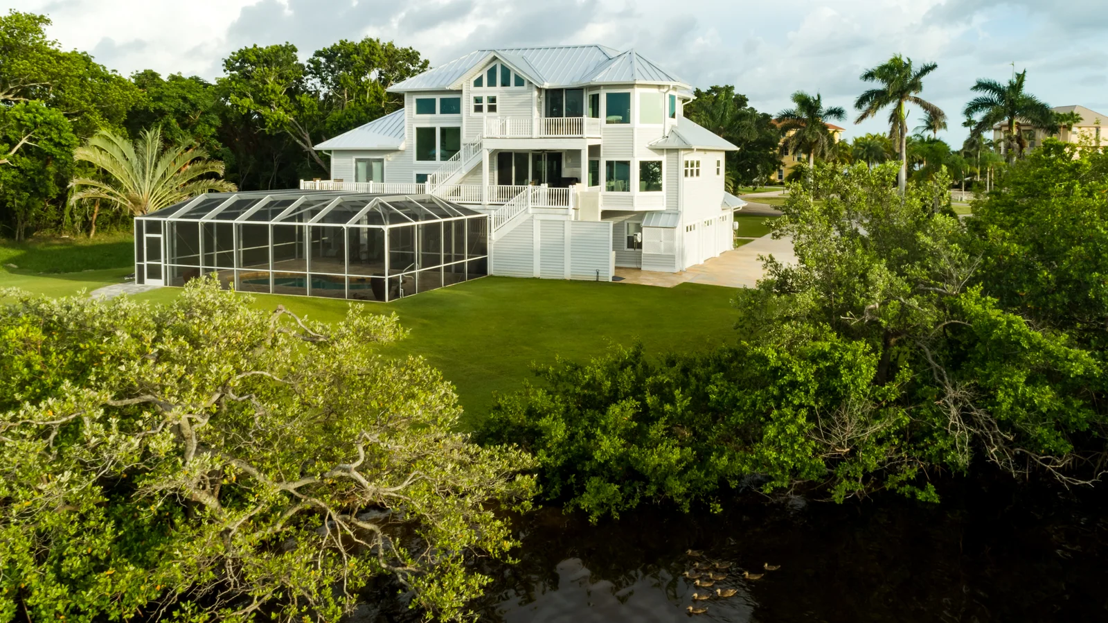 Waterfront view of metal roofing on a raised home, St. James City